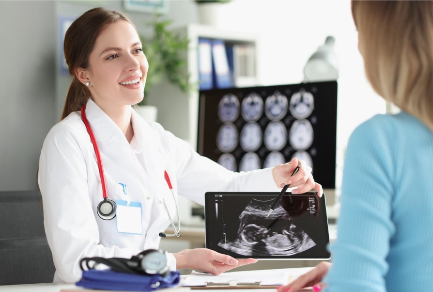 Pediatrician Holding A Sonogram At Our Prenatal Care Center In Germantown, MD